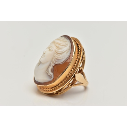 112 - A LARGE 9CT GOLD CAMEO DRESS RING, oval shell cameo depicting a lady, collet set with a fine rope tw... 