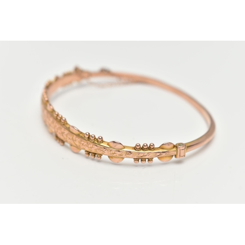 115 - A 9CT GOLD HINGED BANGLE, with ivy leaf pattern and applied bead work surround, Sponsors mark 'S&P',... 