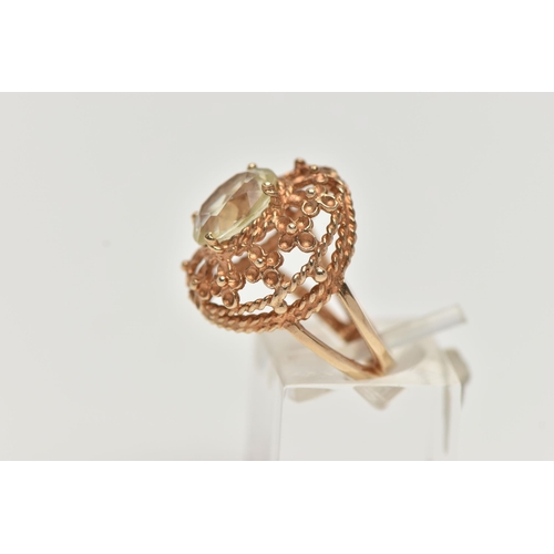 122 - A 9CT GOLD GEM SET RING, set with an oval cut pale green stone assessed as spinel, in a four claw se... 