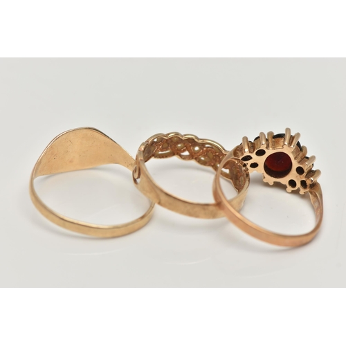 180 - THREE 9CT GOLD RINGS, the first a garnet cluster, hallmarked 9ct London, ring size M, second a squar... 