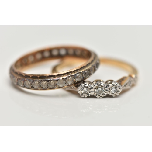 181 - TWO YELLOW METAL RINGS, the first a three stone diamond ring, set with a central round brilliant cut... 