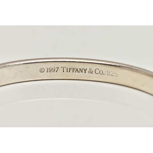 186 - A 'TIFFANY & CO' BANGLE, concaved bangle stamped '925 T&Co 1837', signed to the interior of the band... 