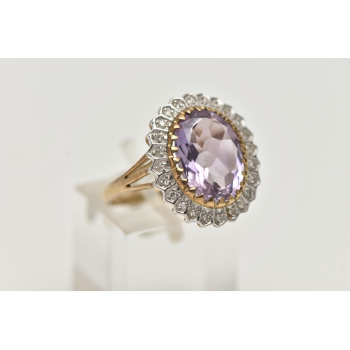 2 - A 9CT GOLD AMETHYST AND DIAMOND DRESS RING, a principal set oval cut amethyst with halo surround of ... 