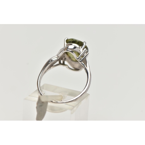 44 - A 9CT WHITE GOLD, TOURMALINE AND DIAMOND RING, designed with an oval cut green tourmaline in a four ... 