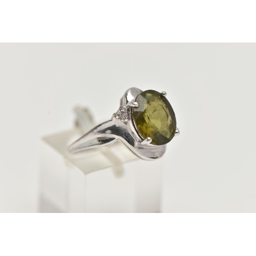 44 - A 9CT WHITE GOLD, TOURMALINE AND DIAMOND RING, designed with an oval cut green tourmaline in a four ... 