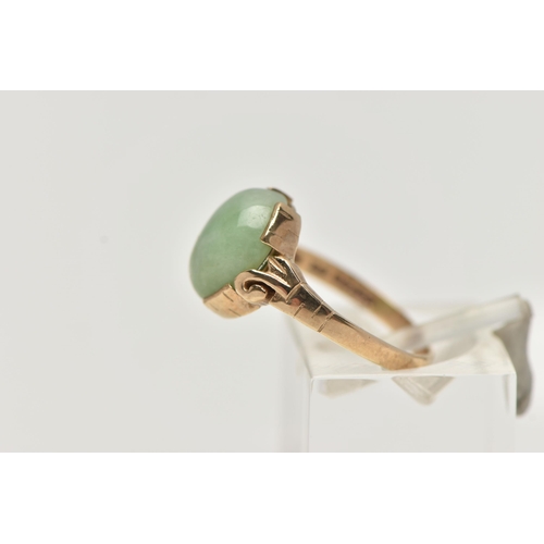 57 - A 9CT GOLD JADE RING, jade cabochon collet set to the scrolling shoulders and polished band, hallmar... 