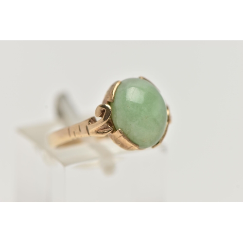 57 - A 9CT GOLD JADE RING, jade cabochon collet set to the scrolling shoulders and polished band, hallmar... 