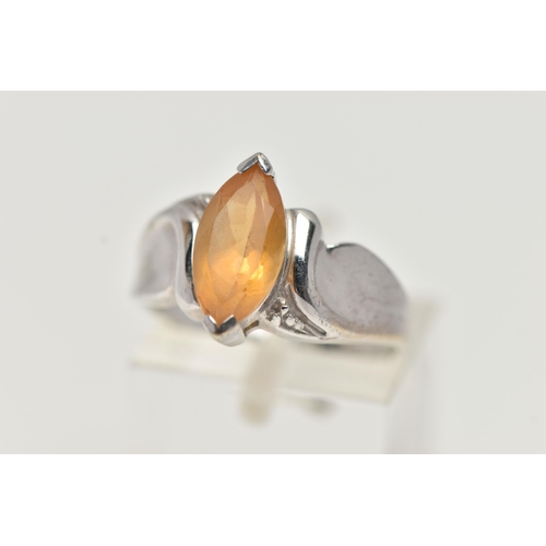 58 - A 9CT WHITE GOLD TOPAZ RING, designed with a marquise cut yellow topaz, to scrolling shoulders and p... 