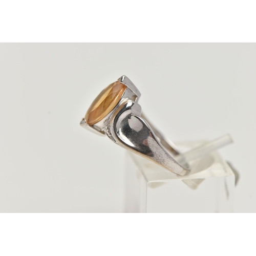 58 - A 9CT WHITE GOLD TOPAZ RING, designed with a marquise cut yellow topaz, to scrolling shoulders and p... 