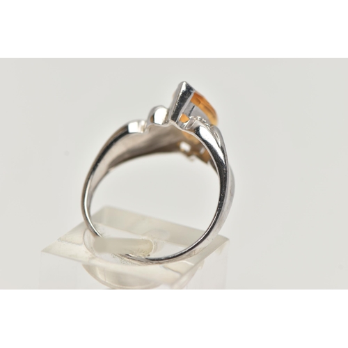 58 - A 9CT WHITE GOLD TOPAZ RING, designed with a marquise cut yellow topaz, to scrolling shoulders and p... 