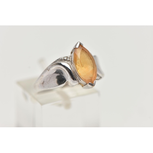 58 - A 9CT WHITE GOLD TOPAZ RING, designed with a marquise cut yellow topaz, to scrolling shoulders and p... 