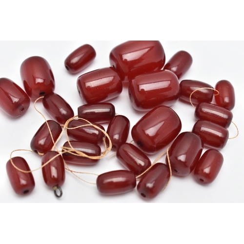 61 - A SMALL BAG OF LOOSE CHERRY AMBER BAKELITE BARREL BEADS, graduated oval beads, visible swirls inside... 