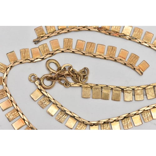 69 - A DAMAGED YELLOW METAL FRINGE NECKLACE, fitted with textured and polished panels, broken into three ... 