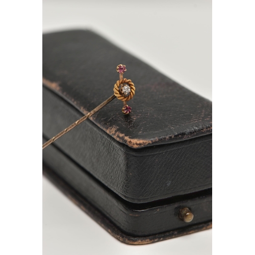 93 - AN EARLY 20TH CENTURY DIAMOND AND GEM STICKPIN, designed as a central old cut diamond within a rope ... 