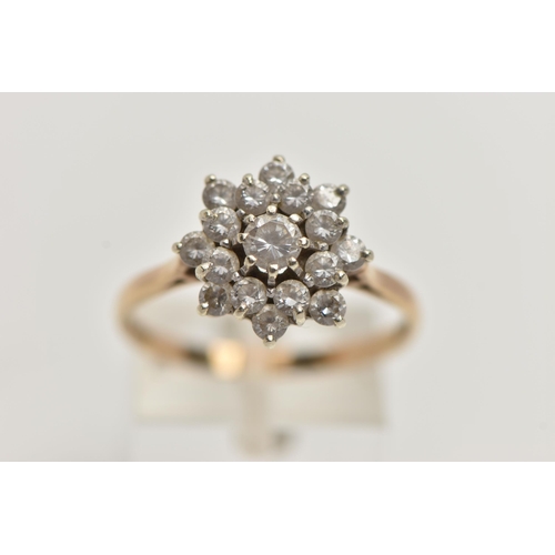 97 - A 9CT GOLD CLUSTER RING, sixteen circular cut cubic zirconia stones, prong set in yellow gold, hallm... 