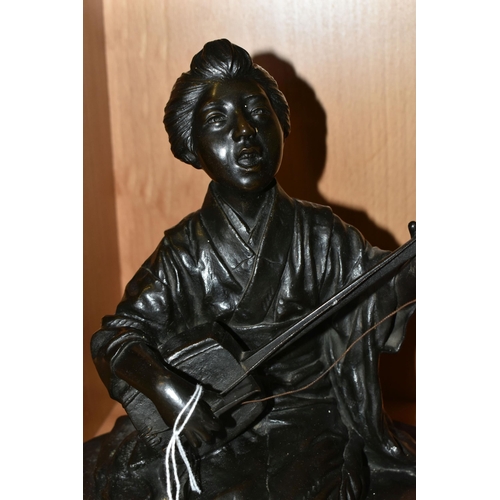 361 - A JAPANESE BRONZE OF A GEISHA KNEELING AND PLAYING A SHAMISEN, cast as singing and with book of musi... 