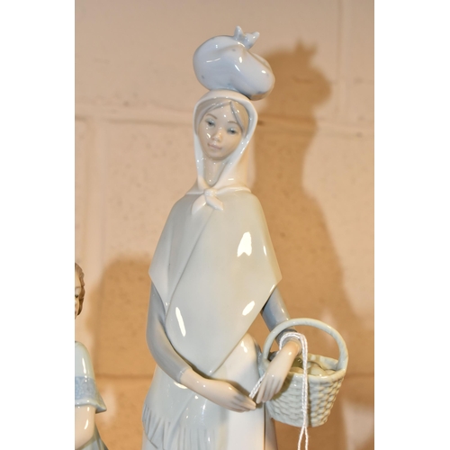 372 - TWO LLADRO FIGURES, comprising Market Day Girl, modelled carrying a basket and with a bundle on her ... 