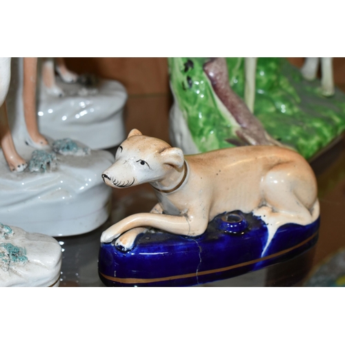 415 - FOUR VICTORIAN STAFFORDSHIRE POTTERY FIGURES OF DOGS STANDING WITH HARES AND A PEN HOLDER, three of ... 