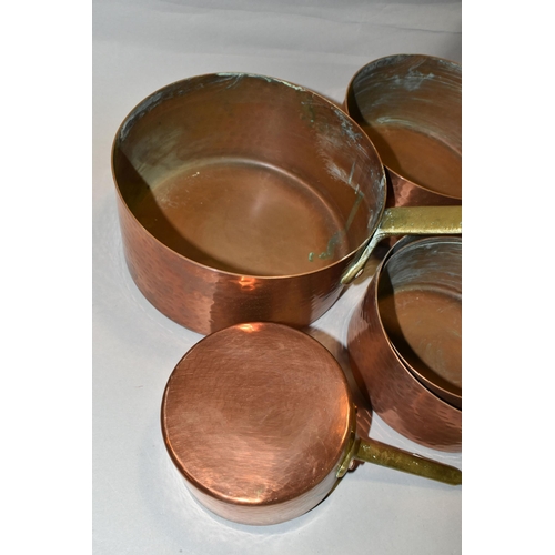 428 - A SET OF FIVE FRENCH COPPER AND BRASS SAUCEPANS, of graduating sizes, diameters 12cm, 14cm, 16cm, 18... 