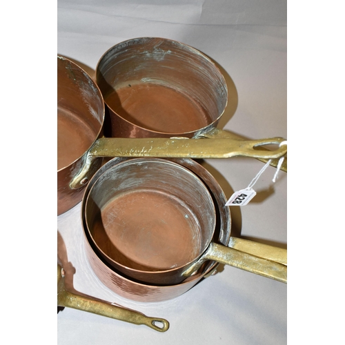 428 - A SET OF FIVE FRENCH COPPER AND BRASS SAUCEPANS, of graduating sizes, diameters 12cm, 14cm, 16cm, 18... 