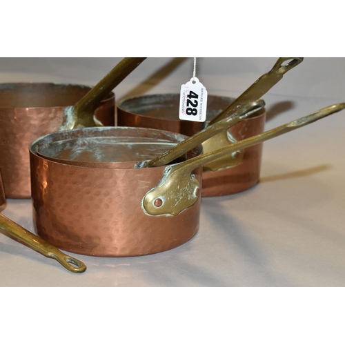 428 - A SET OF FIVE FRENCH COPPER AND BRASS SAUCEPANS, of graduating sizes, diameters 12cm, 14cm, 16cm, 18... 