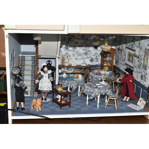 461 - A LARGE WOODEN DOLLS HOUSE 'POPPIES FASHIONS & HABERDASHERY' AND 'WILLOW TEA ROOMS', made by the Dol... 