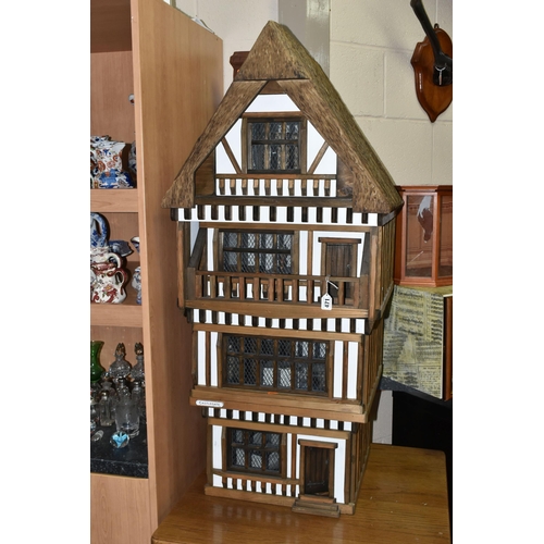 471 - A FOUR STOREY TUDOR WOODEN DOLLS HOUSE, made by Robert Stubbs, model no. F1, detachable magnetic fro... 