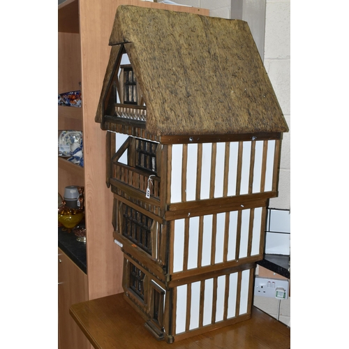 471 - A FOUR STOREY TUDOR WOODEN DOLLS HOUSE, made by Robert Stubbs, model no. F1, detachable magnetic fro... 