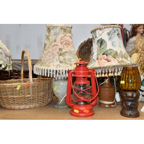 497 - A GROUP OF LAMPS AND BASKETS, comprising a Meva 863 hurricane lamp, three table lamps - one with a t... 