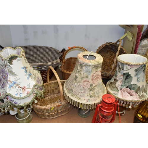 497 - A GROUP OF LAMPS AND BASKETS, comprising a Meva 863 hurricane lamp, three table lamps - one with a t... 