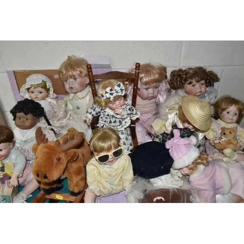 533 - A GROUP OF COLLECTORS DOLLS, twelve baby dolls, including a doll in a crib, a doll on a chair, and a... 