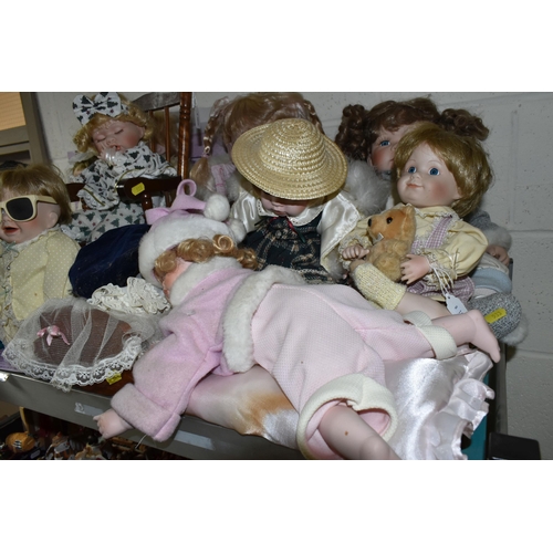 533 - A GROUP OF COLLECTORS DOLLS, twelve baby dolls, including a doll in a crib, a doll on a chair, and a... 