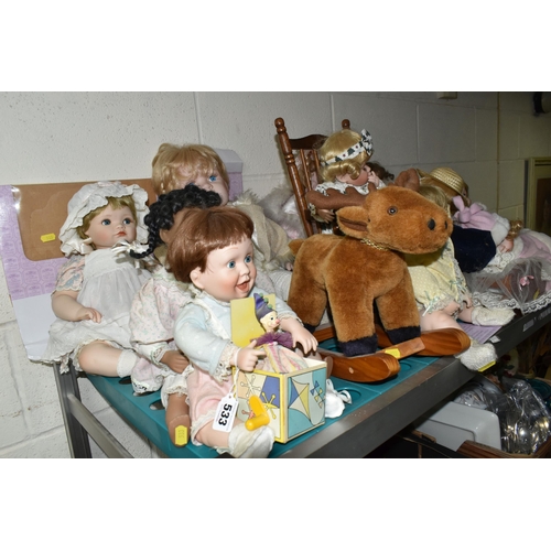 533 - A GROUP OF COLLECTORS DOLLS, twelve baby dolls, including a doll in a crib, a doll on a chair, and a... 