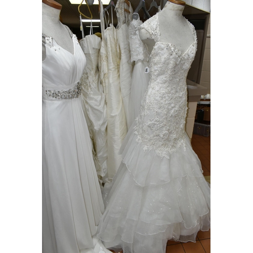 542 - TEN WEDDING DRESSES, retail stock clearance, a collection of styles including Princess line, Mermaid... 