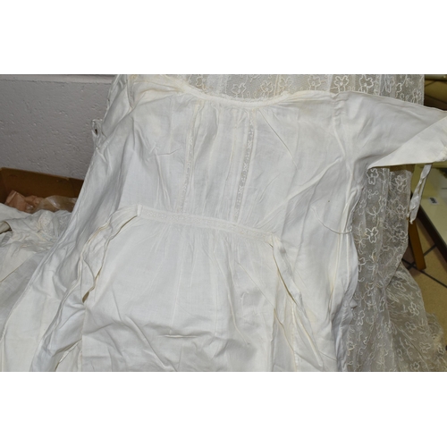 581 - A BOXED WEDDING DRESS AND THREE BABY'S GOWNS, the cream net covered wedding dress approximately size... 