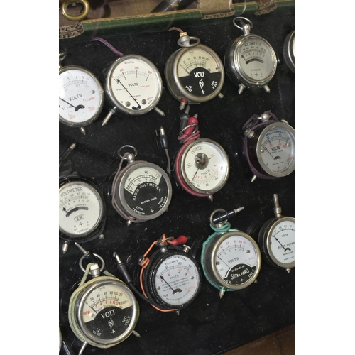 584 - A MODERN DISPLAY CASE CONTAINING VINTAGE POCKET VOLTMETERS makers include Brevete Sifam, Sutra Paris... 