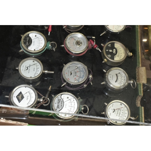 584 - A MODERN DISPLAY CASE CONTAINING VINTAGE POCKET VOLTMETERS makers include Brevete Sifam, Sutra Paris... 