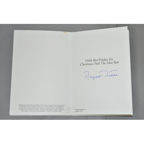 628 - MARGARET THATCHER (1925-1013) A CHRISTMAS CARD SIGNED IN BLUE INK, the front cover has a lithographe... 