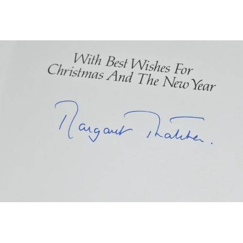 628 - MARGARET THATCHER (1925-1013) A CHRISTMAS CARD SIGNED IN BLUE INK, the front cover has a lithographe... 