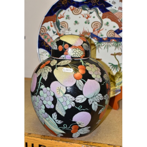 656 - A COLLECTION OF ORIENTAL CHARGERS, comprising a ginger jar decorated with fruit and vines on a black... 