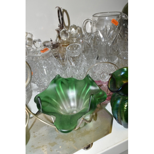 663 - A QUANTITY OF CUT CRYSTAL AND COLOURED GLASSWARE, comprising a green iridescent ribbed glass vase (A... 