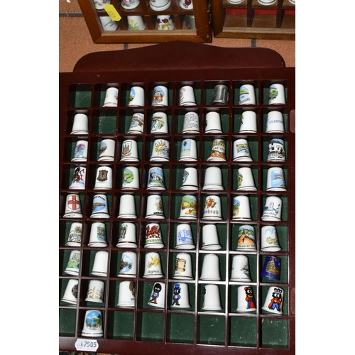 689 - A BOX AND FOUR TRAYS OF THIMBLES, over one hundred and fifty mainly ceramics thimbles by makers incl... 