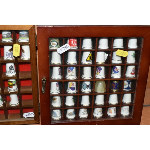 689 - A BOX AND FOUR TRAYS OF THIMBLES, over one hundred and fifty mainly ceramics thimbles by makers incl... 