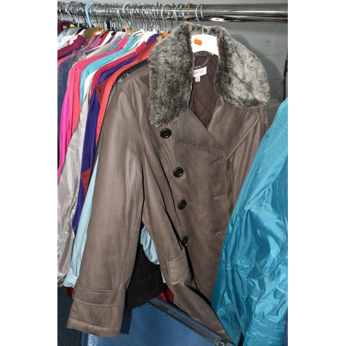 695 - A QUANTITY OF WOMEN'S CLOTHING, to include a black and white fur jacket, a Barbour 'Solway Zipper' w... 