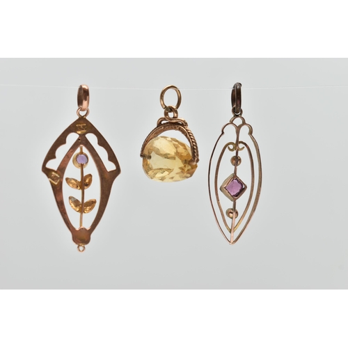 134 - THREE PENDANTS, the first a rose metal openwork floral drop pendant set with a small circular cut am... 