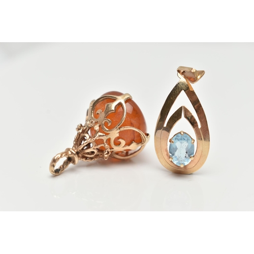 144 - TWO 9CT GOLD PENDANTS, the first an openwork tear drop pendant set with an oval cut blue topaz, fitt... 