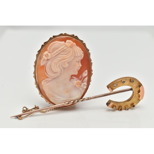 149 - A YELLOW METAL CAMEO BROOCH AND A STICK PIN, the carved shell cameo depicting a lady in profile, col... 