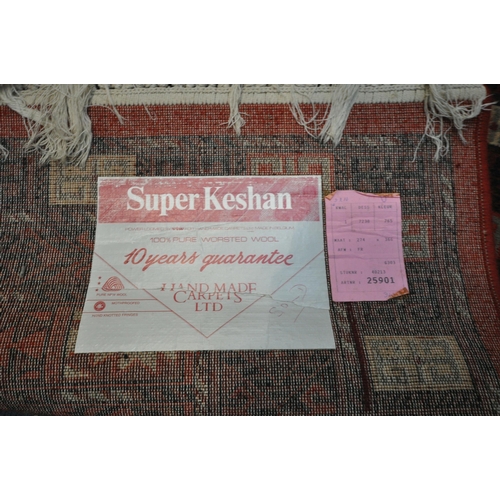 1289 - A LARGE SUPER KESHAN 100% WORSTED WOOL RED GROUND RUG, 366cm x 274cm (condition:-good condition)