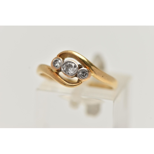 27 - AN 18CT GOLD THREE STONE DIAMOND RING, set with a central old cut diamond, flanked with a round bril... 