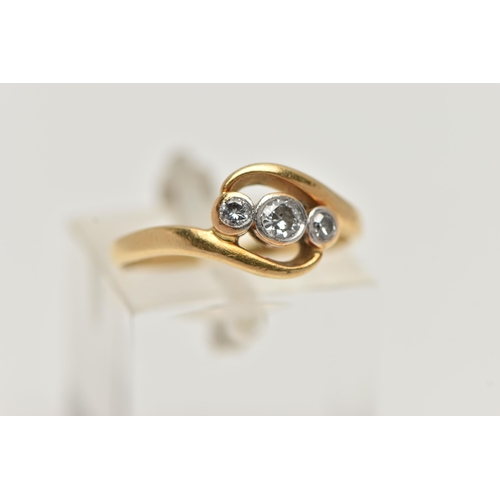 27 - AN 18CT GOLD THREE STONE DIAMOND RING, set with a central old cut diamond, flanked with a round bril... 